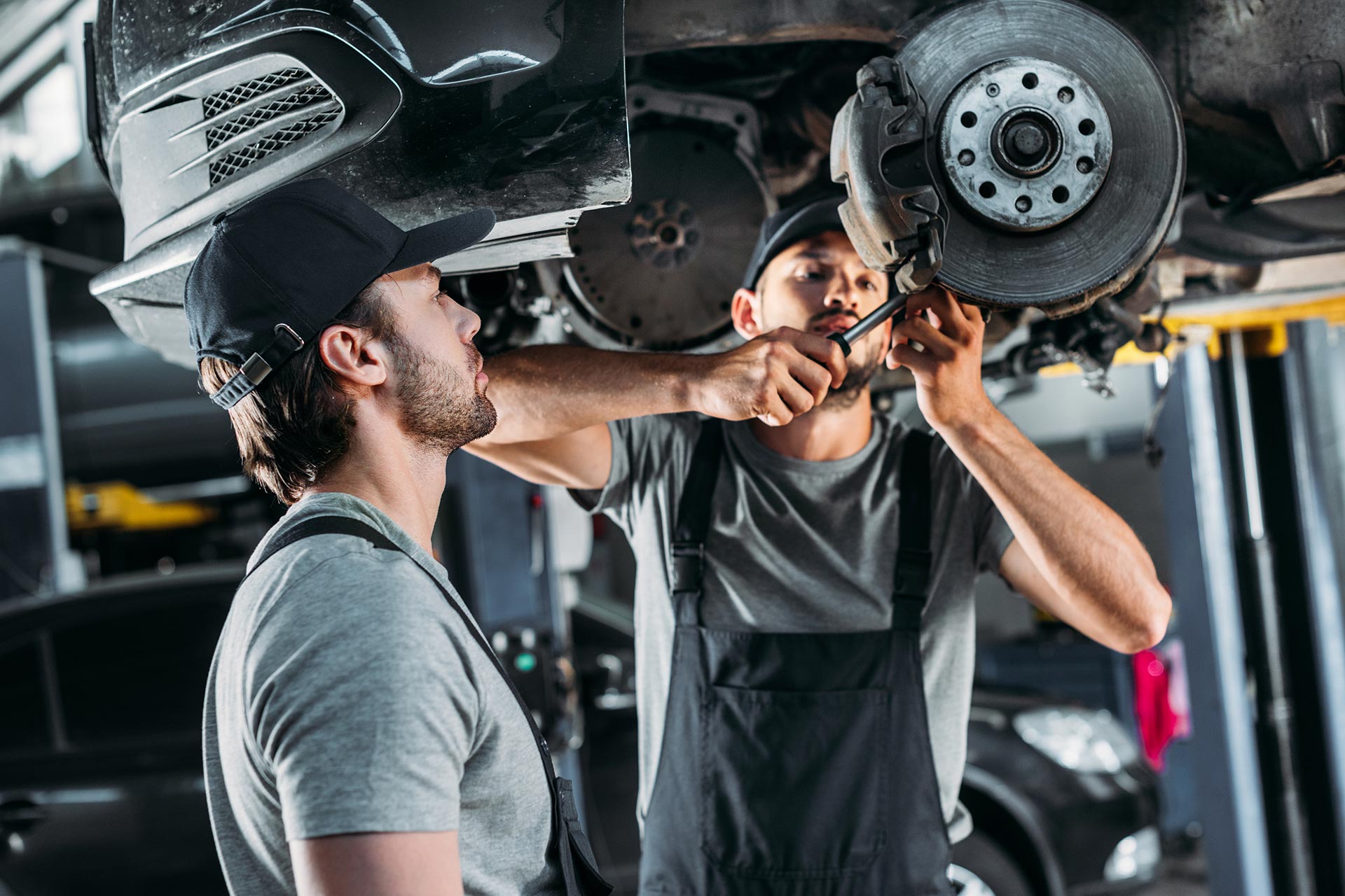 professional mechanics repairing car without wheel 2022 12 16 21 13 54 utc